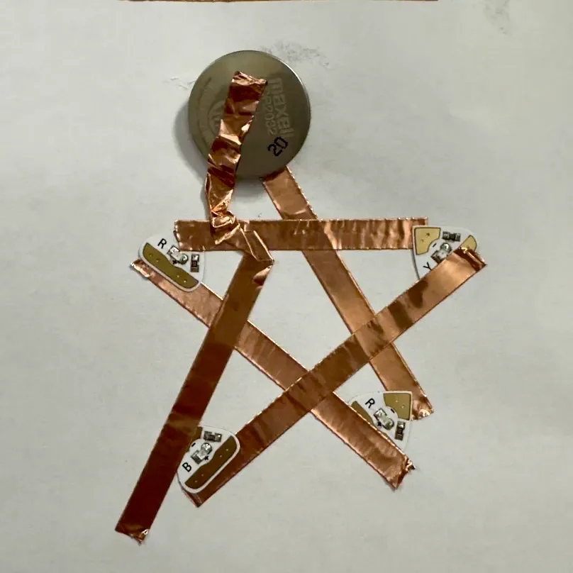 I tried putting both sides of the tape more definitively on the positive and negative sides of the battery. It still didn't work. After discussing the project with my boyfriend who's in mechanical engineering, he said that the electrons were probably skipping out on the LEDs since there's more efficient paths to the battery that don't include the lights. This design would probably work better using tape with non-conductive adhesive.