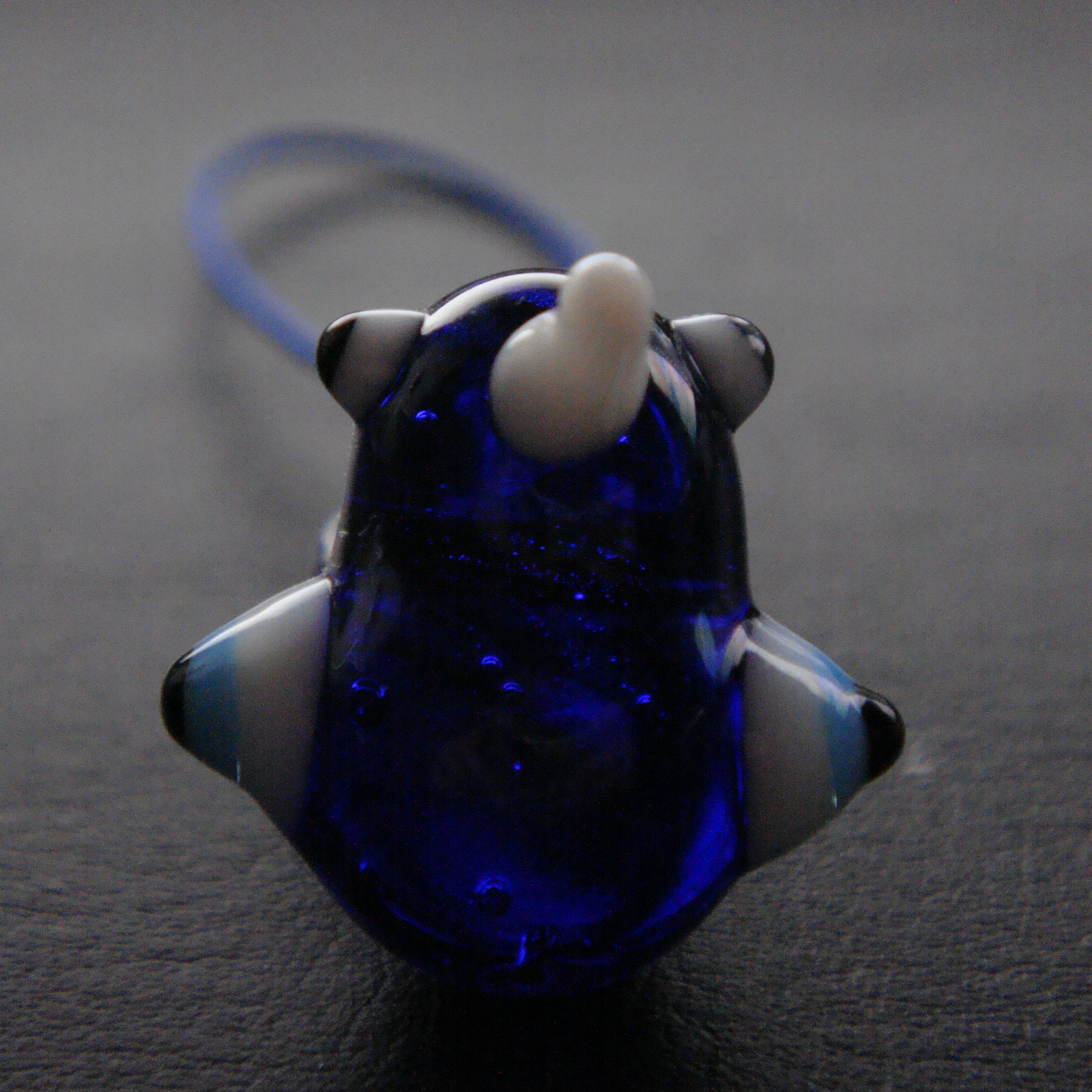 This glass bird hangs over a photo of myself, my brother, and my sister.