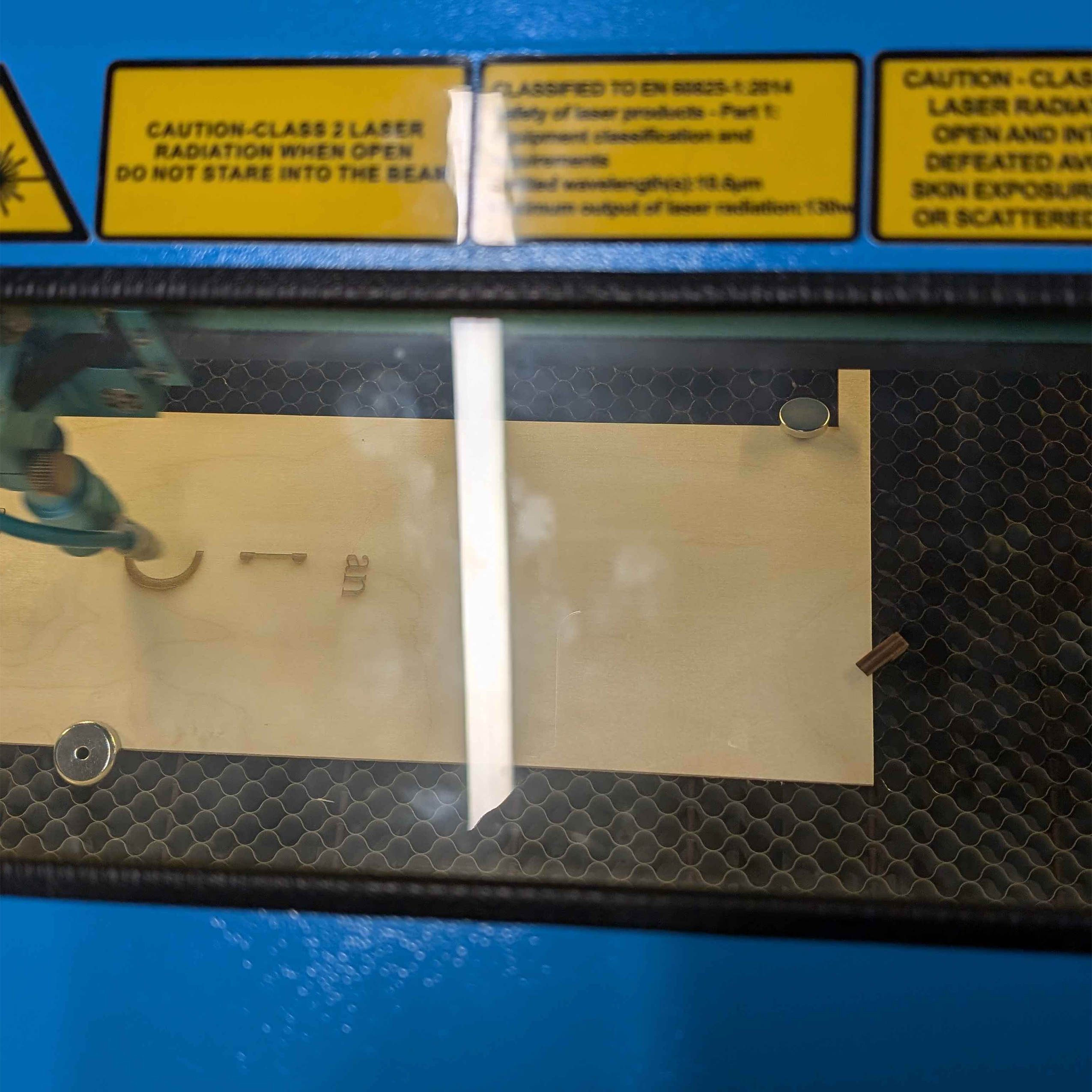 Laser cutting. Lilith, Genevieve, and I decided to share one piece of wood.